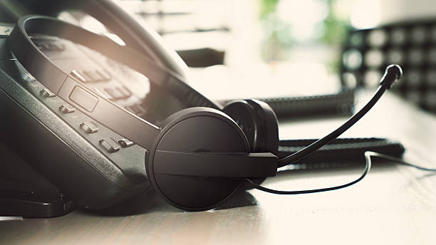 close up headset of call center on office table, operation job concept